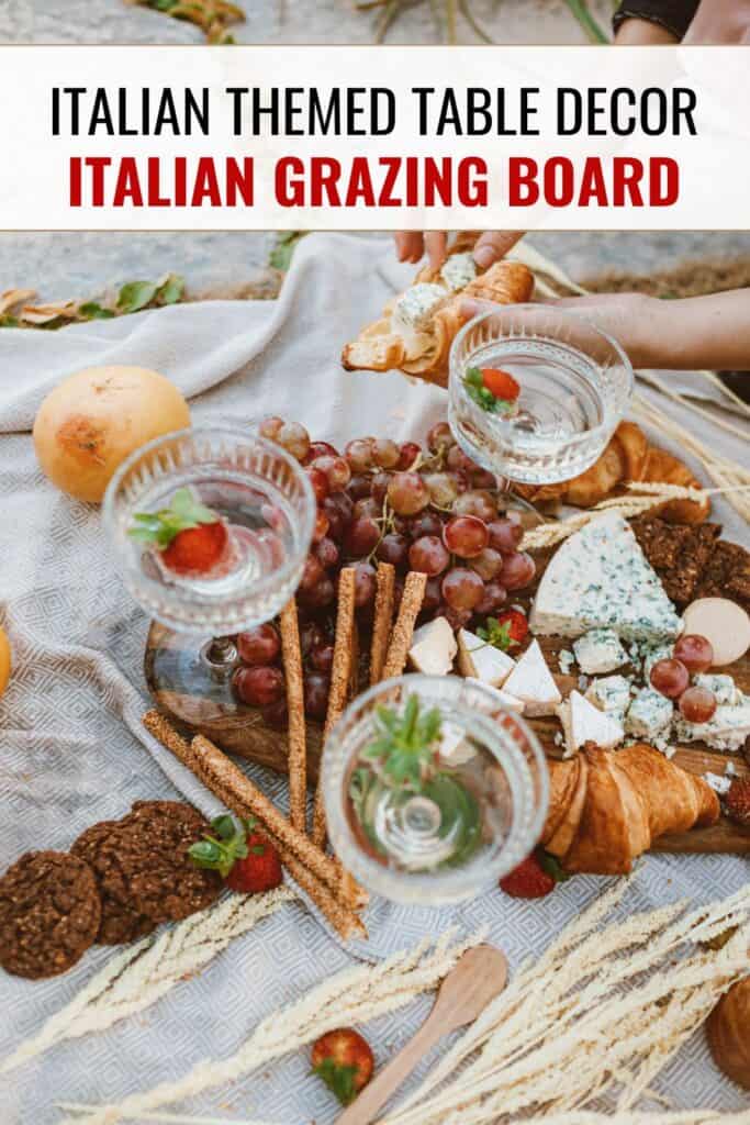 grazing board picnic with meats, cheeses and wine glasses