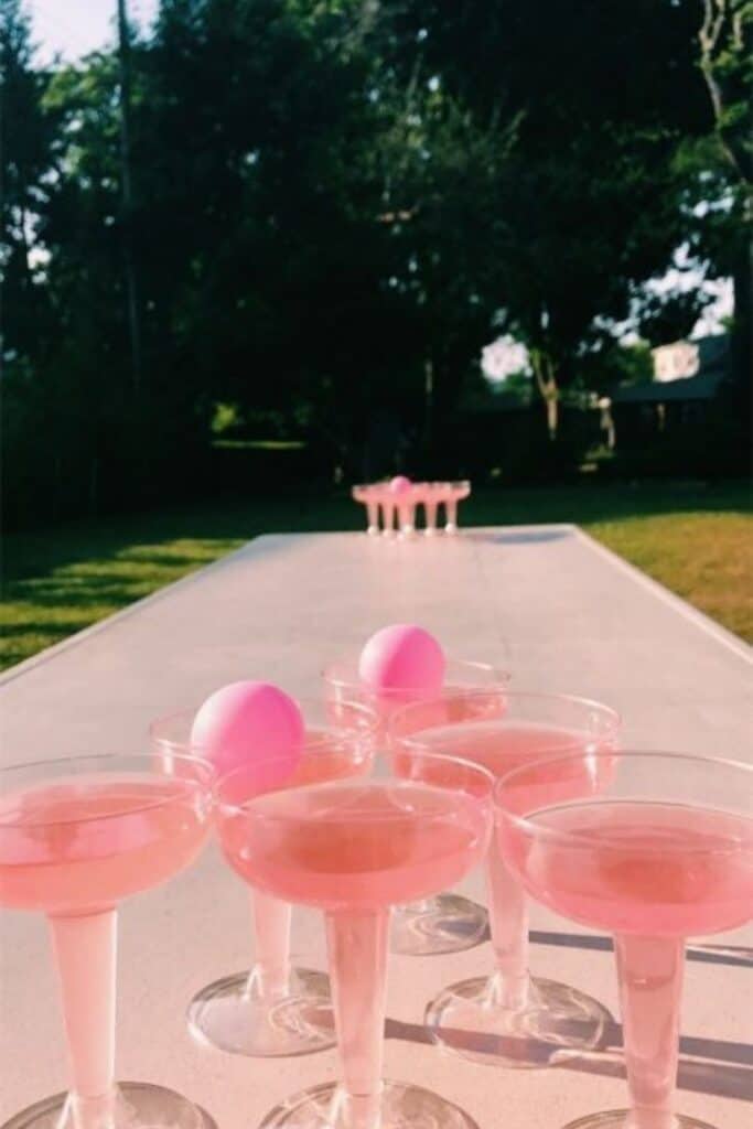 pink prosecco glasses outside on grass for prosecco pong outdoor game