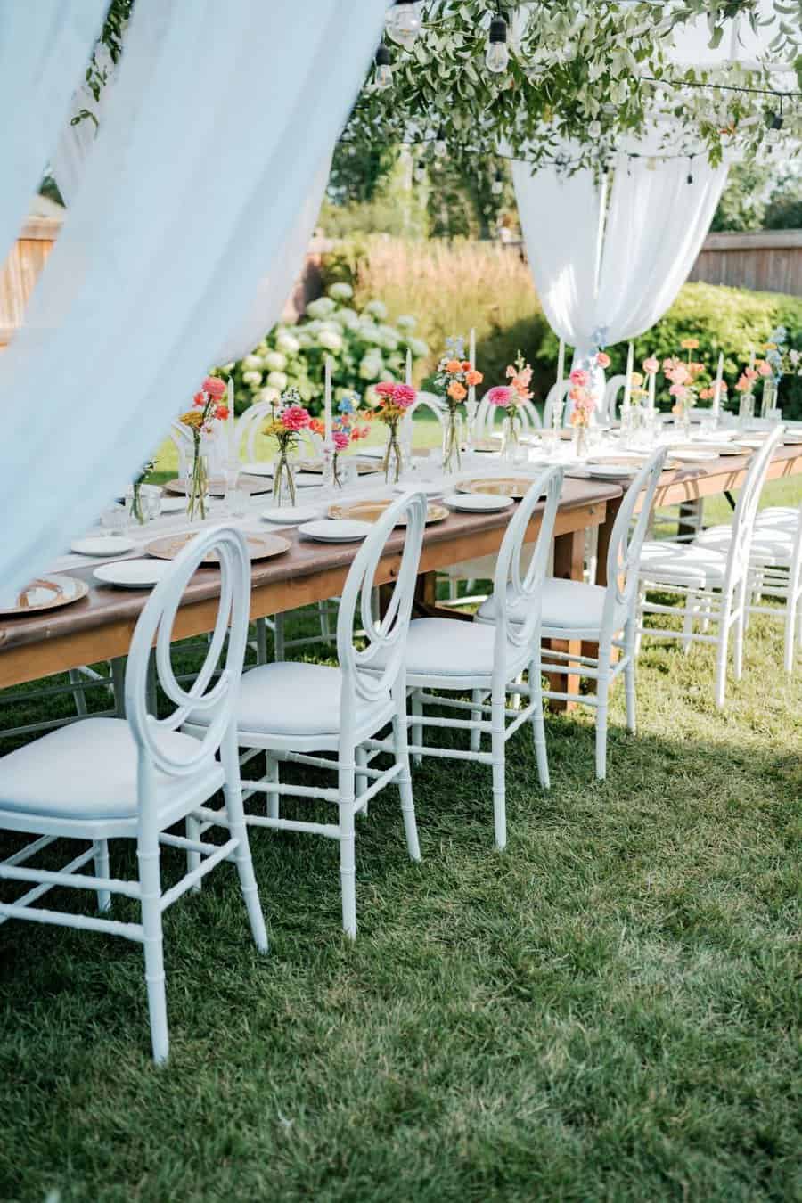 backyard wedding decor white tables with colorful florals