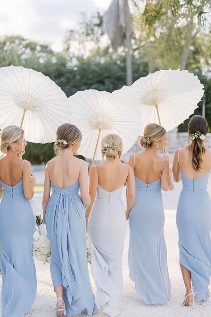 blue bridesmaid dresses and white parasols